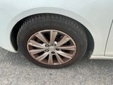 a close up of a tire on a white car
