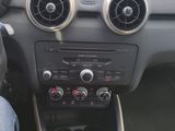 someone is sitting in the driver ' s seat of a car with their feet on the steering wheel