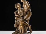 bronze statue of a man and a woman on a rock