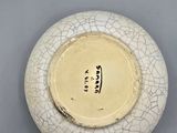 a white bowl with a cracky design on it