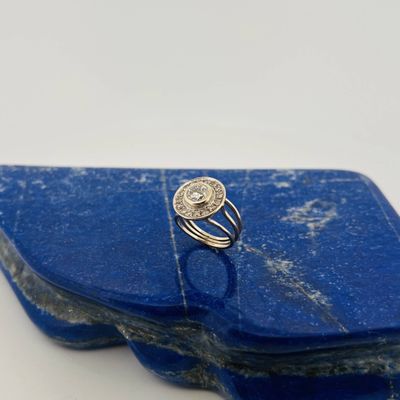 a close up of a blue stone with a silver ring on top of it