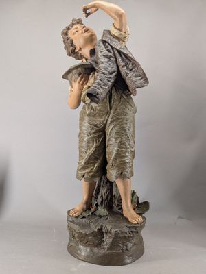 statue of a boy with a bird on his shoulder