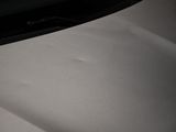 a close up of a car ' s hood with the hood down
