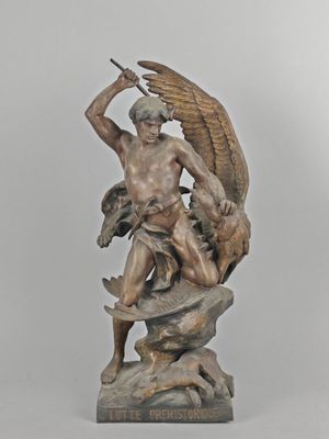 statue of a man holding a sword and a bird on a rock
