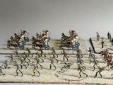many figurines of soldiers in a line on a table