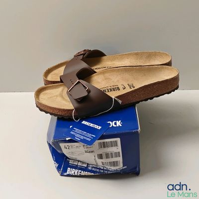 a pair of sandals that are on top of a box