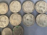 six different types of silver coins sitting on top of a table