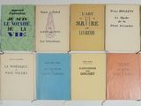 several books are lined up in a row on a white surface