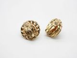 a pair of gold tone earrings