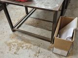 a table with a red toolbox on it in a garage