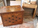 a wooden box sitting on a marble floor next to a table