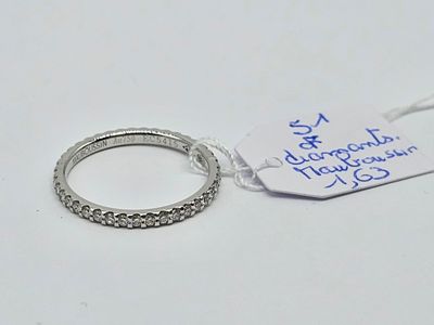 a ring with a price tag on it sitting on a table