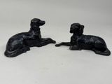 pair of black dog figurines on a white background