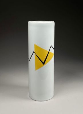 a close up of a white cup with a yellow arrow on it
