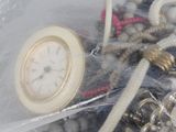 a picture of a bag of jewelry with a clock inside of it
