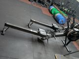 an image of a gym room with a barbell rack and weights