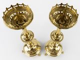 pair of antique brass candlesticks on a white background