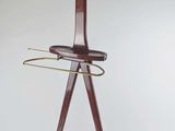 a wooden coat rack with a coat hanger on it