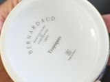 a person holding a white plate with writing on it