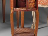 two chairs and a table in a room with a chair in the background