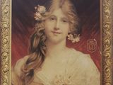 painting of a woman with flowers in her hair in a gold frame