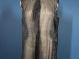 black sleeveless top on a mannequin stand against a blue wall