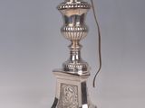 a silver lamp that has a cord attached to it