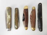 several different types of knives are lined up on a white surface