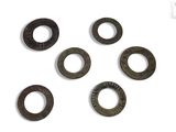 a close up of a bunch of metal washers on a white surface