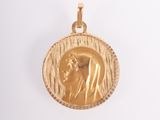 a close up of a gold coin with a woman ' s face on it