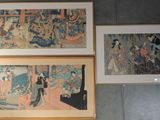 three framed paintings of asian women on a wall in a room