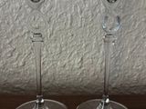 three empty wine glasses sitting on a wooden table