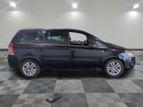 a picture of a black minivan parked in a garage