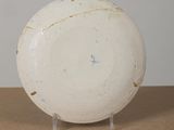 a white bowl sitting on top of a wooden table