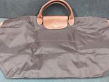 a brown bag sitting on the floor next to a blue carpet