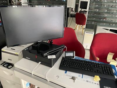 a desk with a computer monitor and keyboard on it