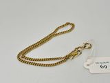 a close up of a gold chain with a tag on it