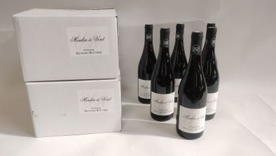 Plusieurs bouteilles de vin sont posées à côté d'une boîte de vin