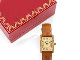 a red box with a gold watch and a red box with a gold watch on it
