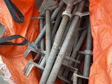 a bag full of bolts and wrenches sitting on the ground
