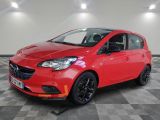 a red opel parked on a checkered floor in a garage