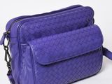 purple leather cross body bag on white background