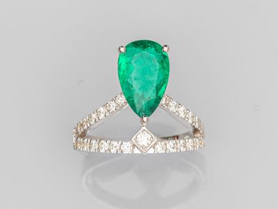 a pear shaped emerald and diamond ring