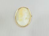 a gold plated ring with a white stone in the center