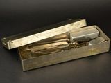 a metal box with a pair of scissors inside of it