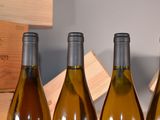 four bottles of wine are lined up in a row on a table