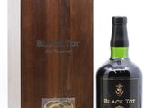 une bouteille de Black Tot à côté d'une chope en cuivre
