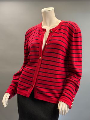 a red and black striped cardigan sweater on a mannequin mannequin