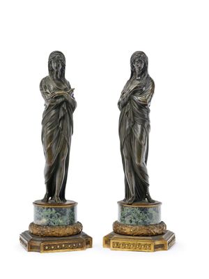 pair of bronze figurines of a woman holding a child