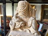 a statue of a woman sitting on top of a table